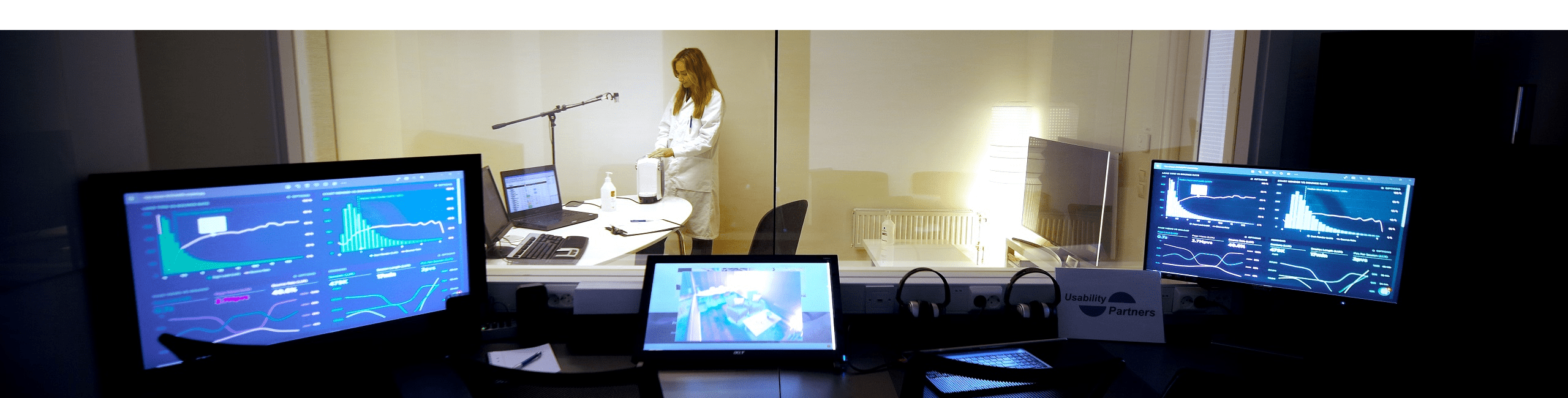 Picture of a usability test room with one way mirror in background